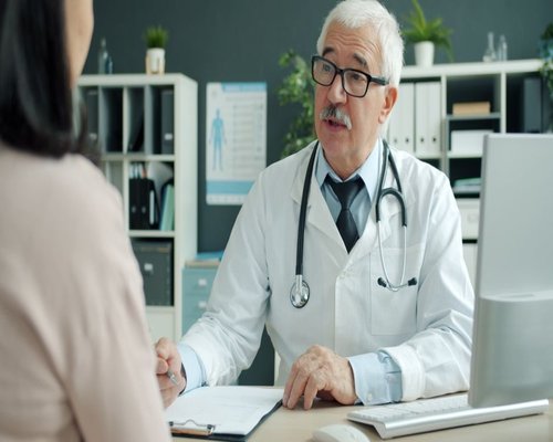 Doctor and adult patient having a calm conversation in a modern consultation room