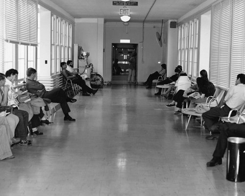 Patient reviewing a list of notes in a waiting area